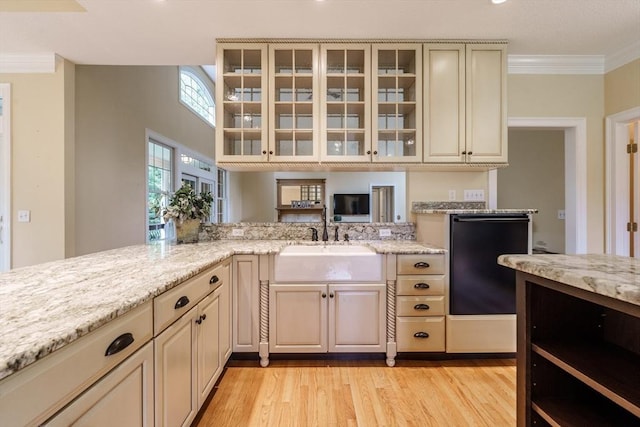 9 Windsor Ln, East Longmeadow, MA 01028 - kitchen featuring cream cabinetry, ornamental molding, light wood-type flooring, light stone counters, and glass insert cabinets