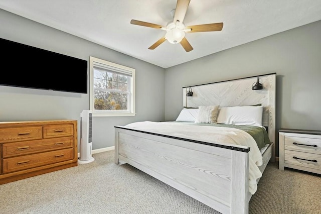 bedroom with a ceiling fan, baseboards, and carpet floors