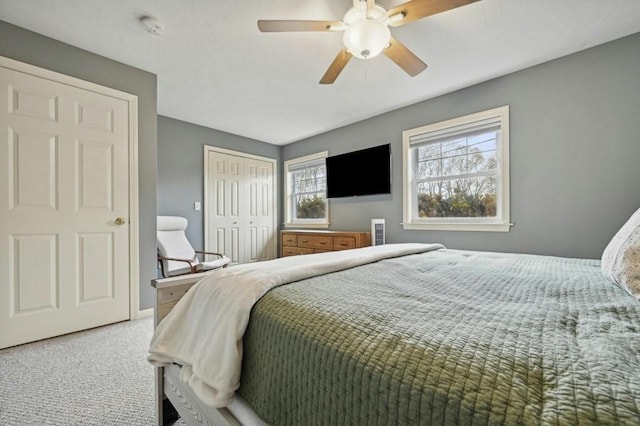 carpeted bedroom with a closet and a ceiling fan