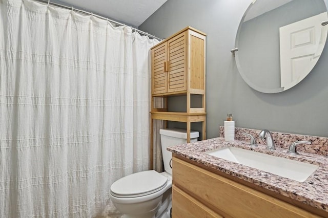 bathroom featuring toilet and vanity