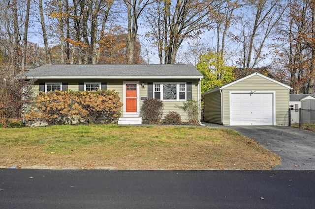 ranch-style house with driveway, entry steps, an outdoor structure, a front yard, and a garage