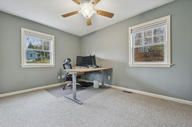 office with visible vents, baseboards, and carpet