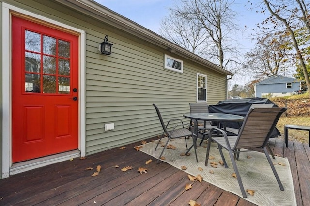 wooden deck featuring outdoor dining area