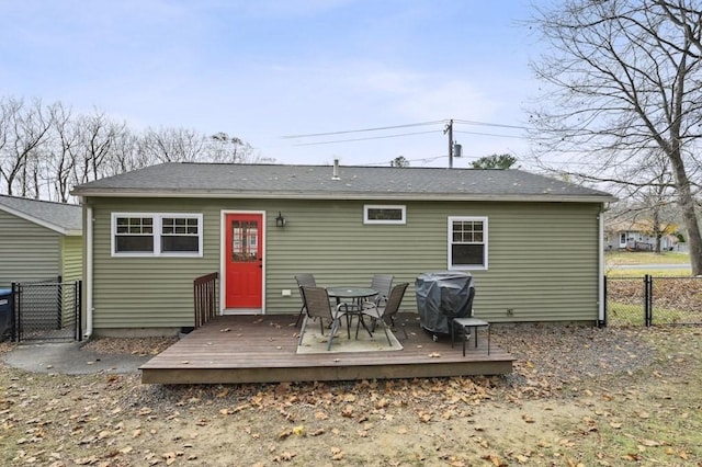 back of house with a gate, a deck, and fence