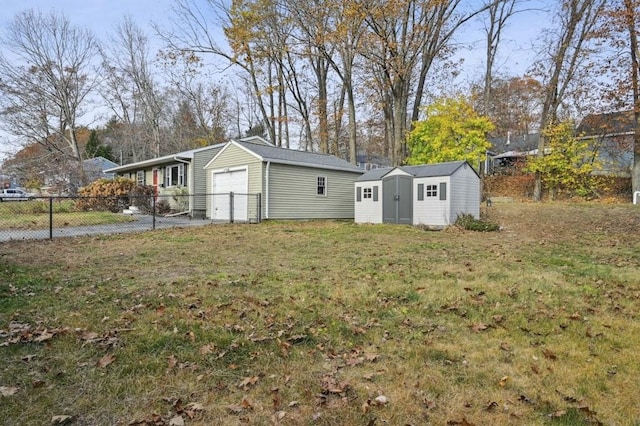 view of yard featuring a storage unit, an outdoor structure, and fence