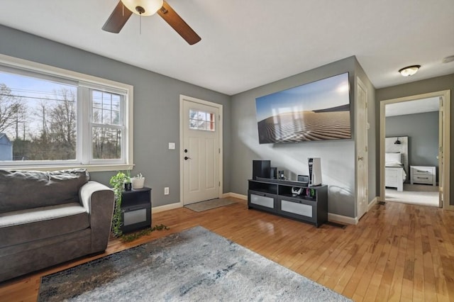 foyer featuring ceiling fan, baseboards, and hardwood / wood-style flooring