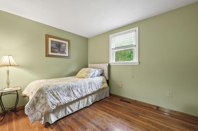 bedroom featuring wood finished floors and baseboards