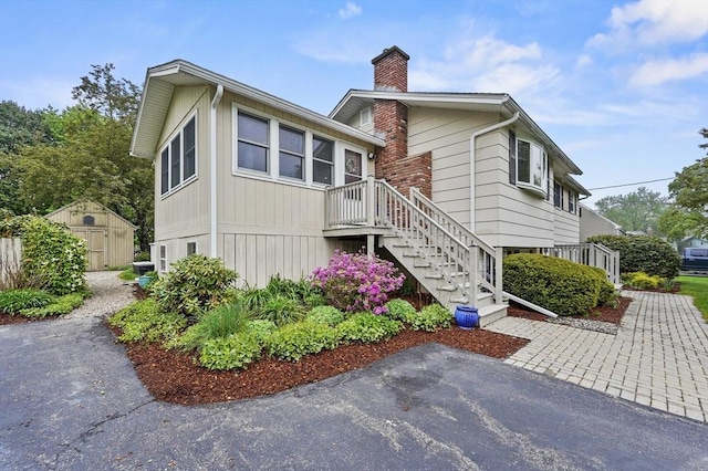 view of front of property with a chimney and stairs