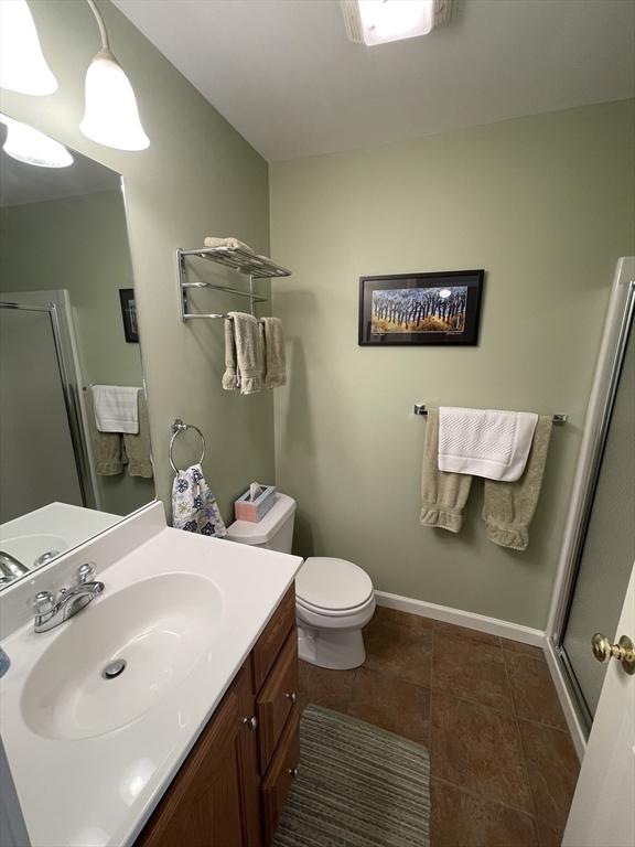 9201 Mountainside Dr Unit 9201, Hancock, MA 01237 - full bathroom with a stall shower, toilet, tile patterned flooring, vanity, and baseboards