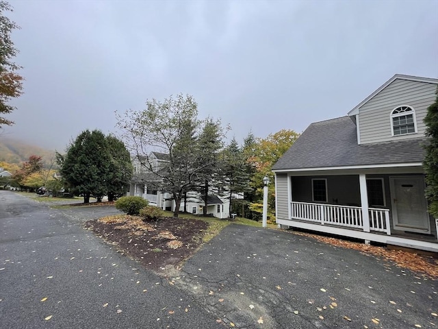 9201 Mountainside Dr Unit 9201, Hancock, MA 01237 - view of property exterior with a porch and a shingled roof
