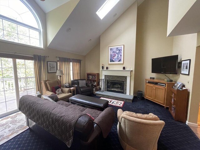 9201 Mountainside Dr Unit 9201, Hancock, MA 01237 - living room featuring high vaulted ceiling, carpet, a fireplace with raised hearth, baseboards, and a skylight