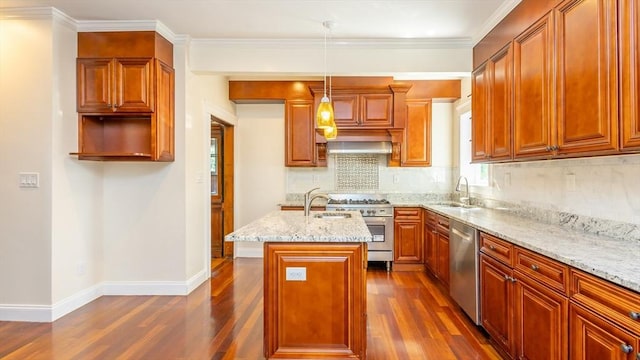 kitchen with light stone countertops, dark wood-style flooring, a sink, decorative backsplash, and appliances with stainless steel finishes