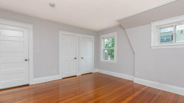 unfurnished bedroom with baseboards and wood finished floors