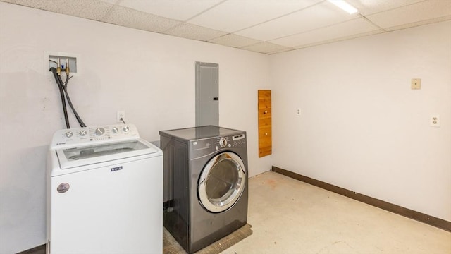 laundry area featuring washing machine and clothes dryer, laundry area, electric panel, and baseboards