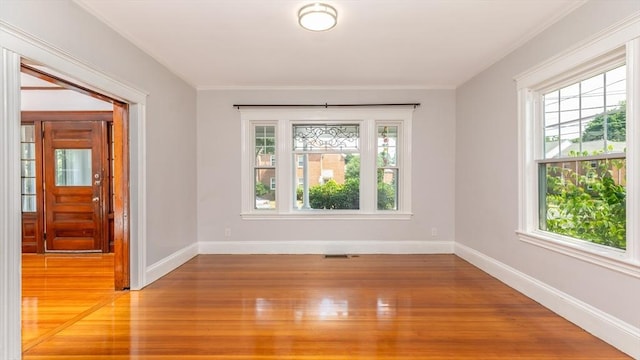 empty room featuring baseboards and light wood-style floors