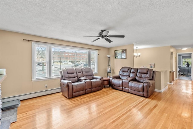 living area with light wood finished floors, ceiling fan with notable chandelier, a textured ceiling, and a baseboard radiator