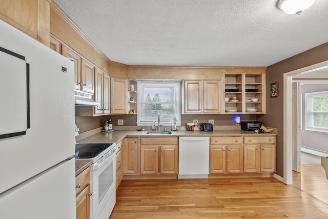 kitchen featuring light brown cabinetry, a sink, white appliances, and open shelves