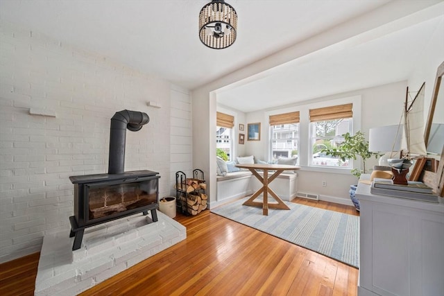 16 Squanto Rd, Weymouth, MA 02191 - home office with wood-type flooring and a wood stove