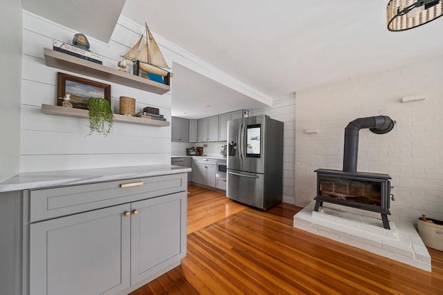 16 Squanto Rd, Weymouth, MA 02191 - kitchen with stainless steel fridge, gray cabinetry, open shelves, light wood finished floors, and ornamental molding