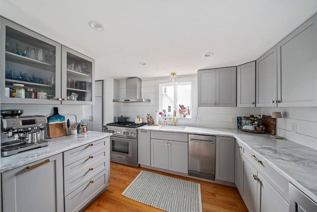 16 Squanto Rd, Weymouth, MA 02191 - kitchen with stainless steel appliances, wall chimney exhaust hood, gray cabinets, glass insert cabinets, and recessed lighting