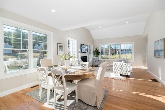62 High St Lot 1, Stoneham, MA 02180 - dining room featuring lofted ceiling, a fireplace, light wood-style flooring, and recessed lighting