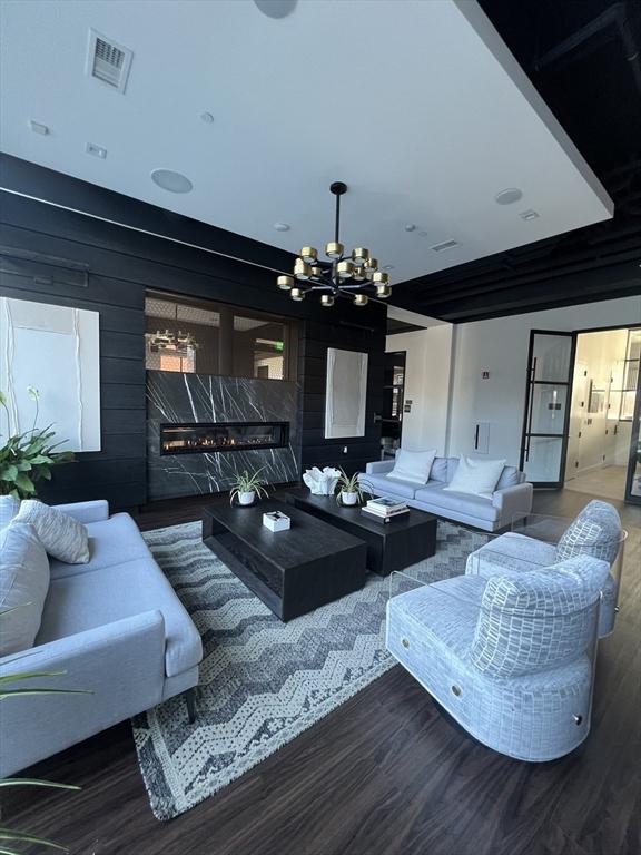 99 Sumner St Unit 503, Boston, MA 02128 - living room featuring a chandelier, wood finished floors, and a high end fireplace
