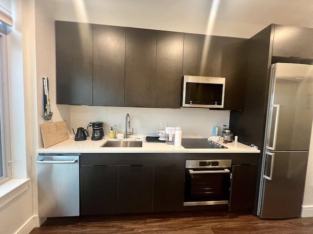 99 Sumner St Unit 503, Boston, MA 02128 - kitchen featuring appliances with stainless steel finishes, a sink, light countertops, and dark wood finished floors