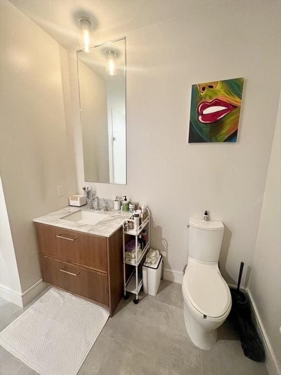 99 Sumner St Unit 503, Boston, MA 02128 - bathroom featuring vanity, toilet, baseboards, and tile patterned floors