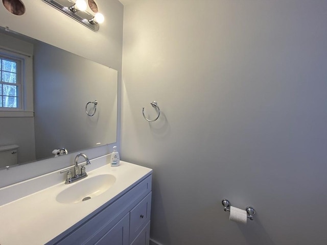 bathroom featuring toilet and vanity