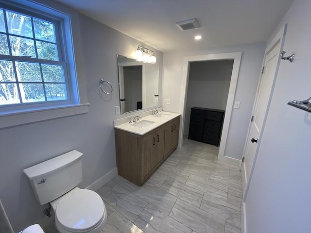 bathroom featuring toilet and vanity