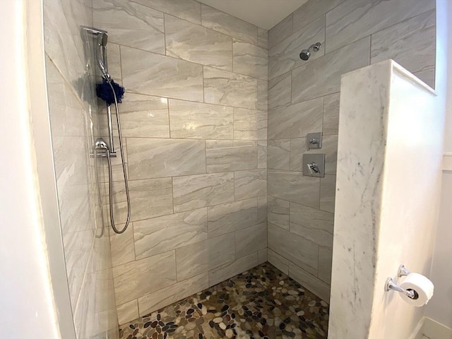 bathroom with tiled shower