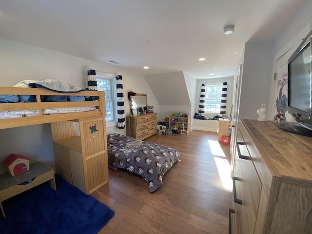 bedroom with dark wood-type flooring and vaulted ceiling