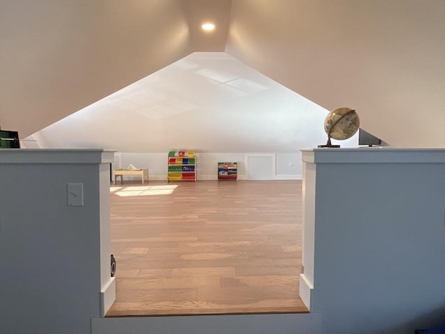 interior space with vaulted ceiling and hardwood / wood-style flooring