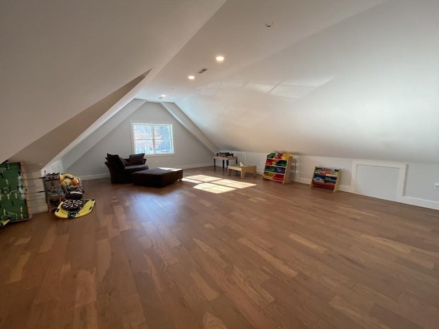 additional living space with vaulted ceiling and wood-type flooring