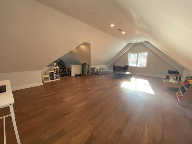 additional living space featuring lofted ceiling and wood-type flooring