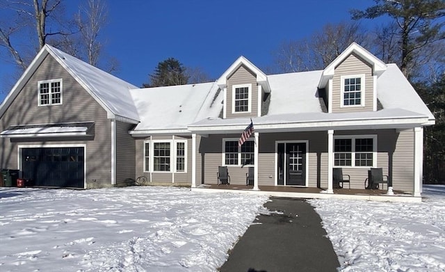 new england style home with a porch and a garage