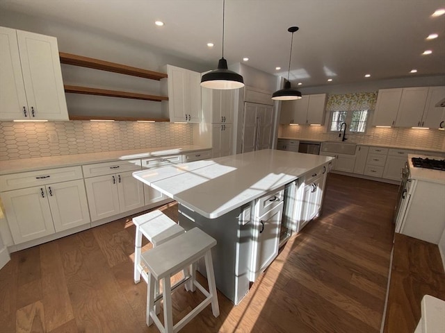 kitchen with white cabinetry, dark hardwood / wood-style flooring, and a kitchen island