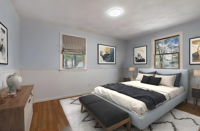 bedroom featuring baseboards and wood finished floors