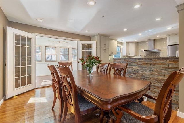 dining area featuring light wood finished floors and recessed lighting