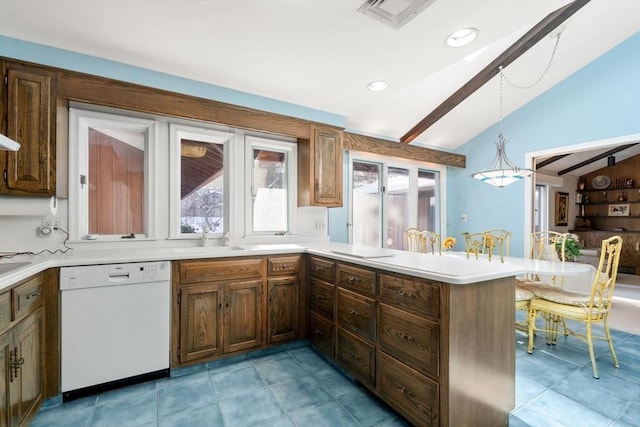 kitchen featuring dishwasher, lofted ceiling, sink, hanging light fixtures, and kitchen peninsula