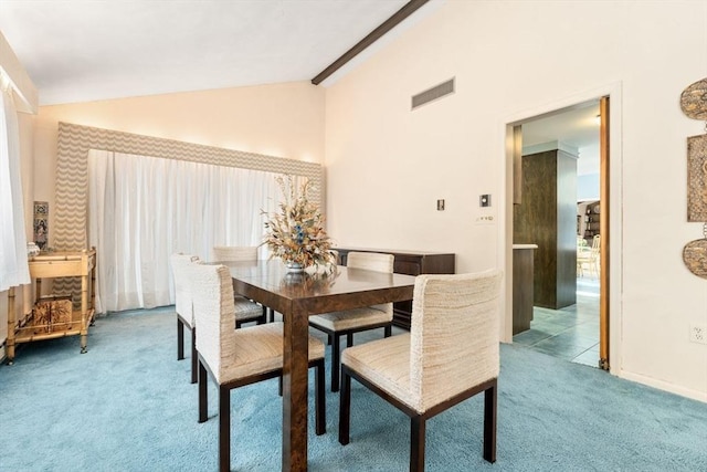 dining room with light colored carpet and lofted ceiling