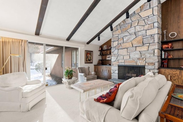 living room featuring carpet floors, a stone fireplace, lofted ceiling with beams, and a wealth of natural light