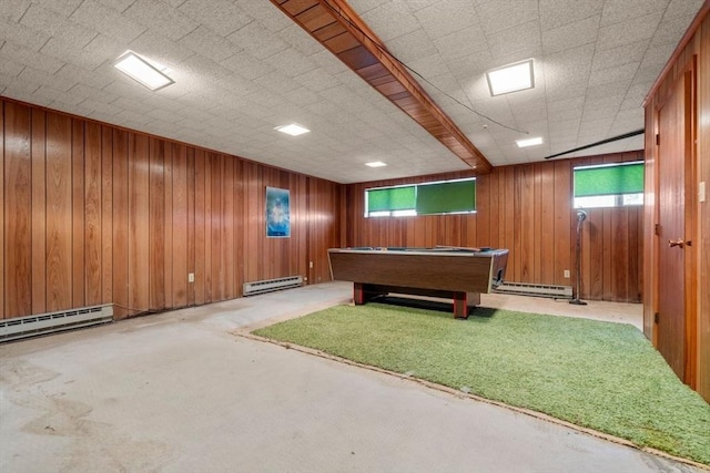 playroom with wood walls and baseboard heating