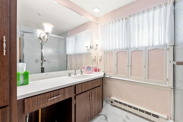 bathroom featuring walk in shower, vanity, and a baseboard heating unit