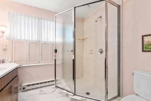 bathroom with vanity, toilet, a shower with shower door, and a baseboard heating unit