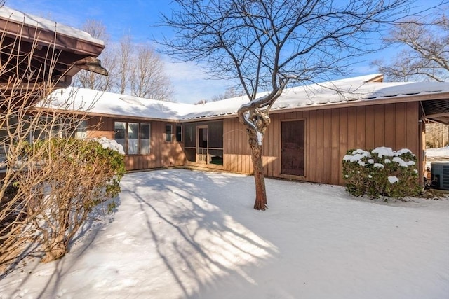 view of snow covered rear of property