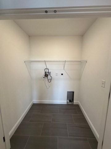 laundry area featuring electric dryer hookup, laundry area, and baseboards