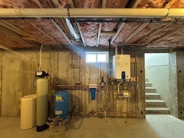 basement with water heater and stairs