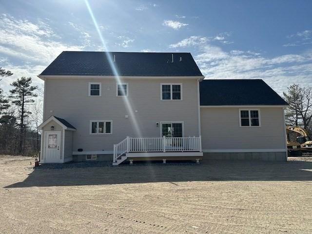 back of property featuring a wooden deck