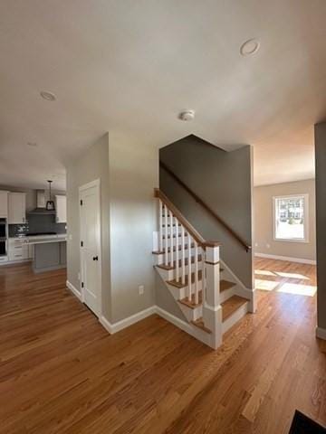 stairs featuring baseboards and wood finished floors
